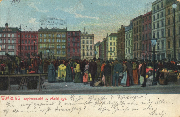 Alte Postkarte, die eine belebte MarktSzene in Hamburg, Deutschland, zeigt, mit Menschen, Tischen voller Waren, Straßenlaternen, Schildern, Gebäuden und einem bewölkten Himmel, mit Text unten.